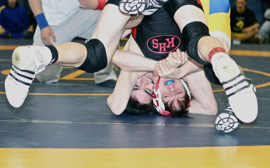 Two-time Far East champion Marcus Boehler of Nile C. Kinnick and St. Mary's International's Kelly Langley find their world turned upside down during Saturday's 122-pound championship bout in the 38th Kanto Plain Association of Secondary Schools Wrestling Tournament at Yokota High School, Japan. Boehler won a three-period decision, 0-6, 11-4, 6-0.