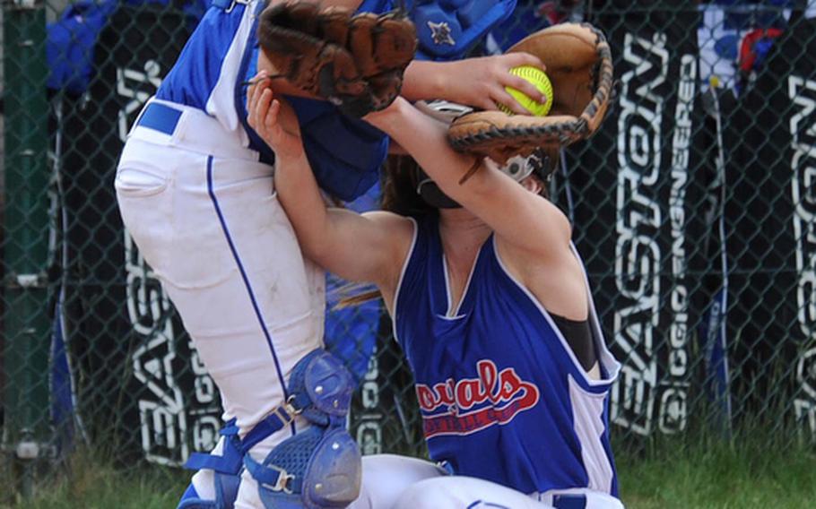 Ramstein catcher Alexis Weathers, left, holds on to foul pop-up despite colliding with teammate Amber Vannaman in the Royals' 10-7 win over Kaiserslautern in a Division I semifinal at the DODDS-Europe softball championships in Ramstein on Friday.