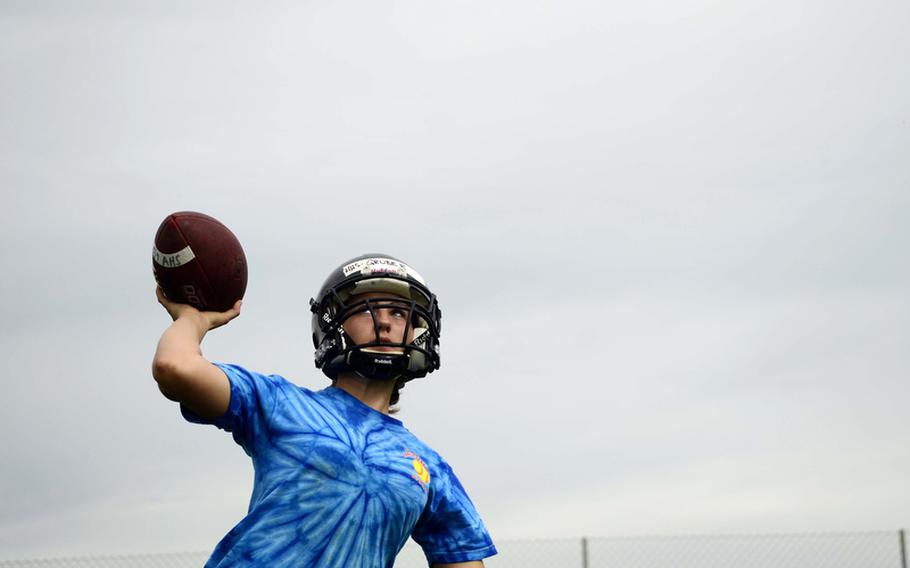 Anna Gruber, 16, a sophomore from Hohenfels High School, goes through  quarterback drills at this year's DODDS-Europe football camp in Ansbach, Germany. More than 350 football players from eight American high schools and five local national teams are participating in the annual preseason football camp that ends Wednesday.