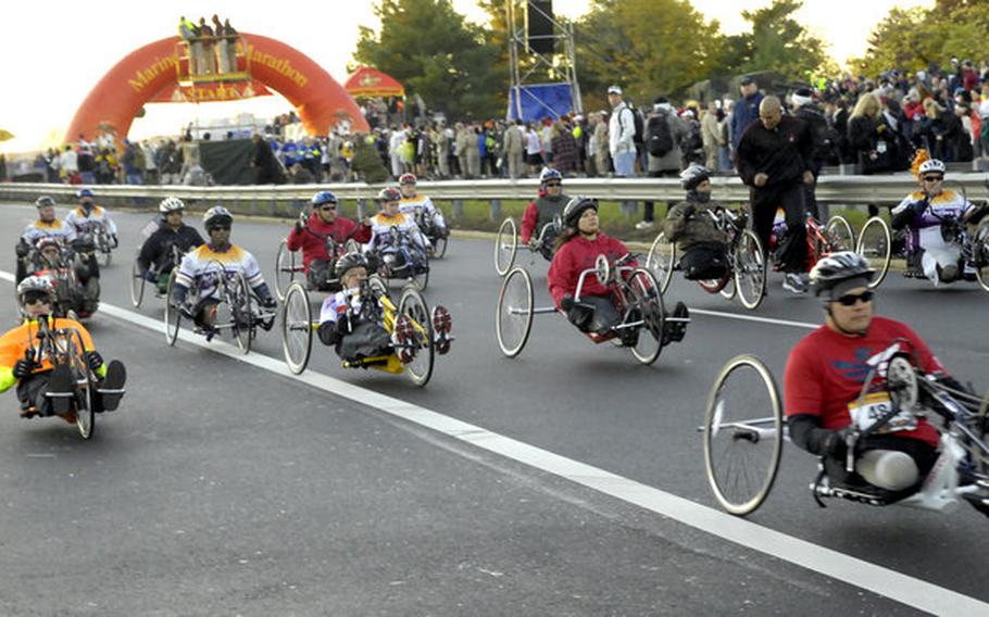 Wheelchair and hand cycle competitors break from the starting line.