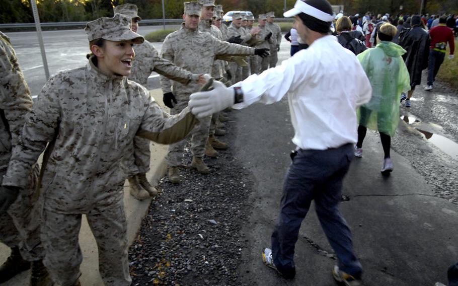Some of the hundreds of Marines who helped out at the race offer encouragement to runners heading to the starting line.