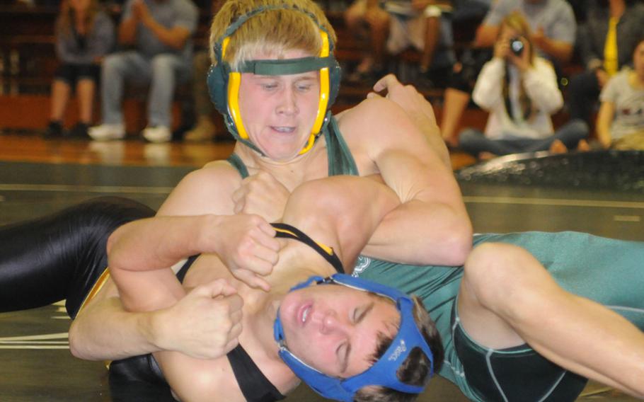 Kubasaki's Austin Cyr wrenches the shoulders of Kadena's Justin Sego to the mat during Wednesday's 122-pound bout in an Okinawa Activities Council preseason wrestling scrimmage at Kubasaki High School. Cyr pinned Sego in 2 minutes, 21 seconds. Team scores weren't kept. The two teams open the season Dec. 6.