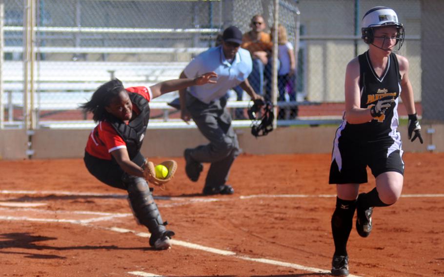 Schweinfurt's Brattany Waters catches a foul ball as Patch's Jennifer Sparks runs for first base during the first game of a doubleheader Saturday at Patch Barracks.