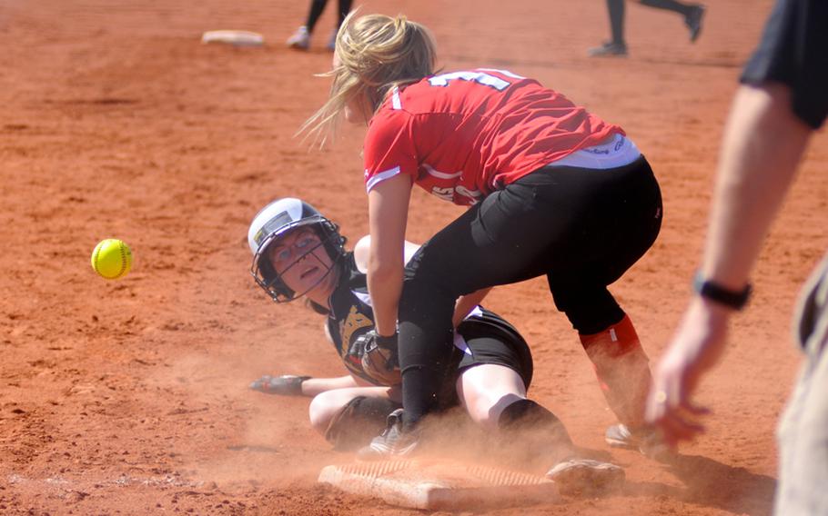 Patch's Katelyn Tingey slides into third base as Schweinfurt's Ashley Dowdy drops the ball just after catching it during the first game of a doubleheader Saturday at Patch Barracks.