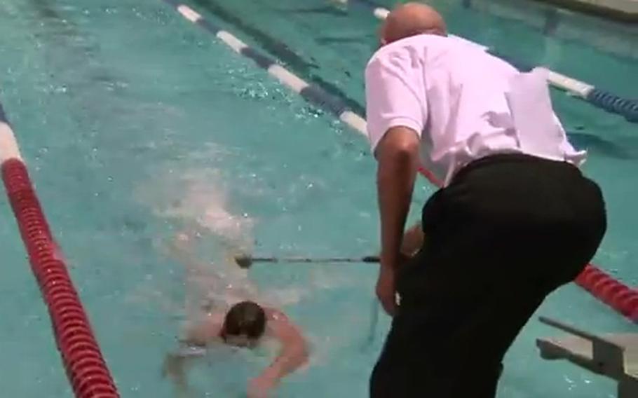 Navy Lt. Brad Snyder competes at a meet sanctioned by the International Paralympic Committee in Colorado Springs, Colo., in February of 2012. Snyder, who is blind, is notified as he approaches the wall.