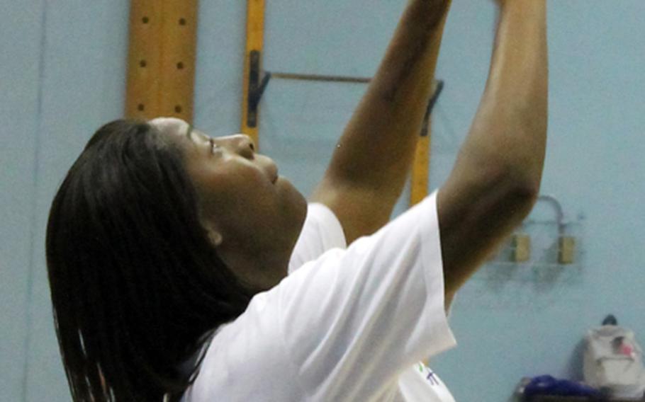 Seoul American Falcons senior weakside hitter Raven Harrison sets the ball during Thursday's practice.