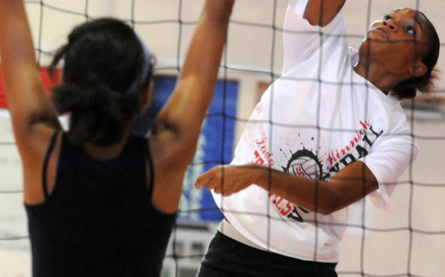 Nile C. Kinnick Red Devils senior middle blocker Mashiya McKinney, right, is one of several returning players who hope to finally cross the Far East Division I Tournament title threshold that has eluded coach Al Garrido in his six seasons at Kinnick's helm.