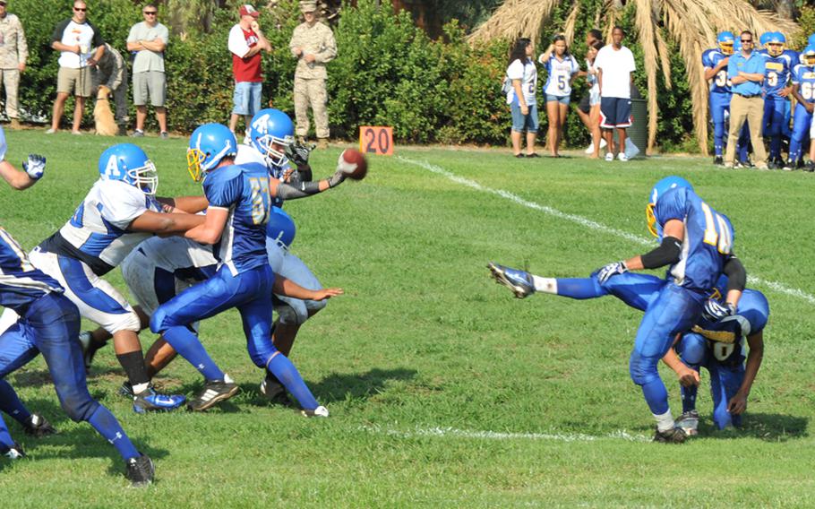 Sigonella's Collin Gantt tries to kick a field goal Saturday in his team's season-opening football game, but Rota blocked it in a 42-0 Admirals victory.