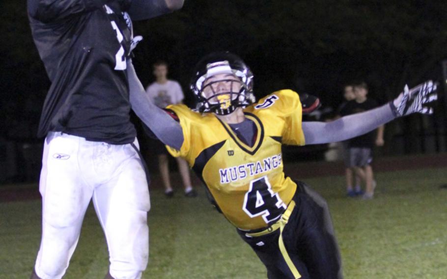 Zama American receiver David Coleman snags a two-point conversion pass over American School In Japan defender Drogin James during Friday's Kanto Plain Association of Secondary Schools football game at Camp Zama, Japan. ASIJ won 24-8.
