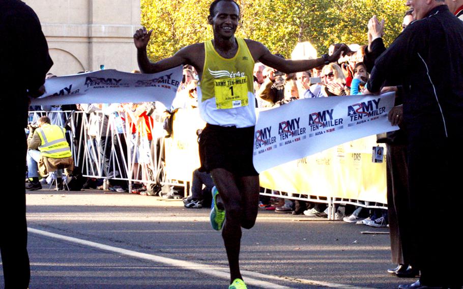 Tesfaye Sendeku Alemayehu of Ethiopia crosses the finish line at the Pentagon as the winner of the 2012 Army Ten-Miler.