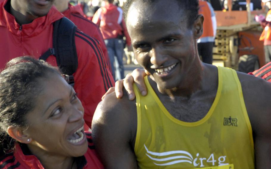 Tesfaye Sendeku Alemayehu of Ethiopia is congratulated after crossing the finish line at the Pentagon as the winner of the 2012 Army Ten-Miler.