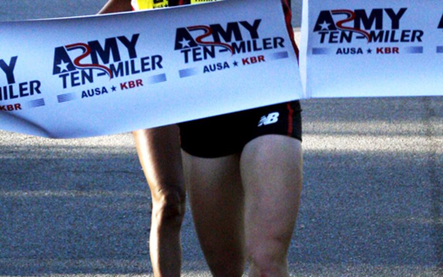 Kerri Gallagher of Washington, D.C. crosses the finish line at the Pentagon as the women's champion in the 2012 Army Ten Miler.