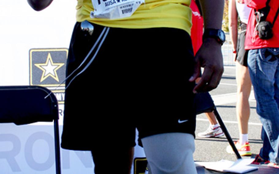 Chief Warrant Officer 2nd Class Johnathan Holsey displays his finish coin after the race.