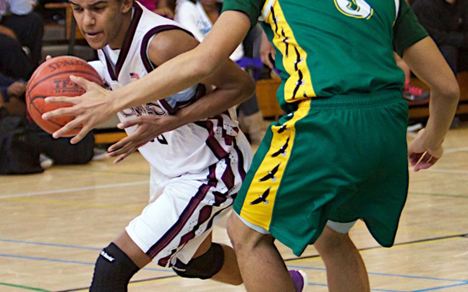 Zama American's Andrae Adams drives against Robert D. Edgren's Louis Murphy during a DODDS Japan basketball tournament boys game at Misawa Air Base, Japan. Adams transferred to Zama from American School In Japan and has been called the final piece of the puzzle that led the Trojans to the Far East Division II title, coach Parish Jones said. Adams has been named Stars and Stripes Pacific high school boys basketball Player of the Year.