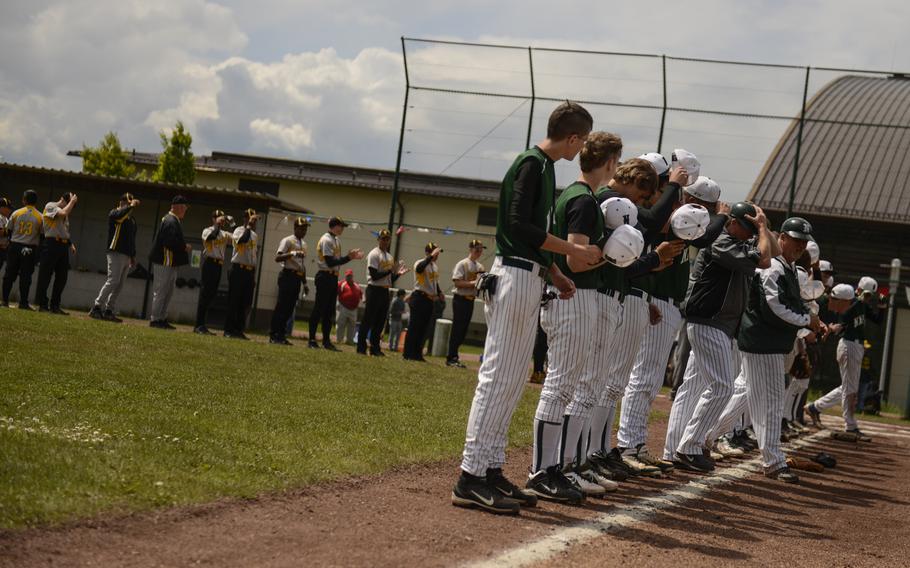 Naples, foreground, and Vicenza head to their dugouts after the national anthem in the Division II & III championship game Saturday afternoon in the 2013 DODDS-Europe baseball championships at Ramstein Air Base, Germany.