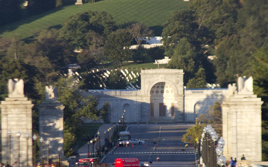 With the early-morning sun illuminating the Custis-Lee Mansion and Arlington National Cemetery in the background, competitors in the wheelchair and hand-crank categories of the Army 10-Miler cross the bridge into Washington, D.C. on Oct. 20, 2013.