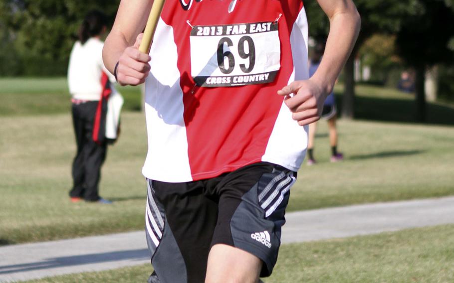 St. Maur International runner Bert Nunnely crosses the finish line during Tuesday's team relay in the Far East High School Cross-Country Meet at  Naval Air Facility Atsugi, Japan. St. Maur won the Division II team relay and repeated as overall school D-II champion.