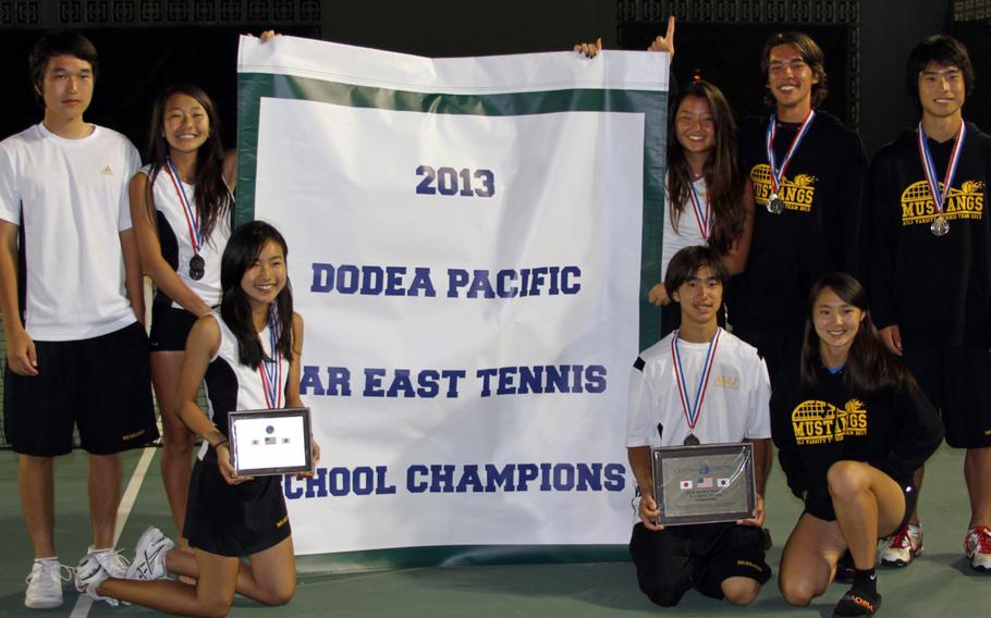 American School In Japan players strike a pose with the overall school Division I banner Thursday following the Far East High School Tennis Tournament at Kadena Air Base, Okinawa. The Mustangs also won the boys D-I title and three event gold medals, boys singles and doubles and mixed doubles. From left, top row Kentaro Ishihara, Lili Kobayashi, Teri Cho, Luke Yamasaki and Yosuke Higashi; bottom row Nana Yoshimura, Len Kamemoto and Saki Fujita.