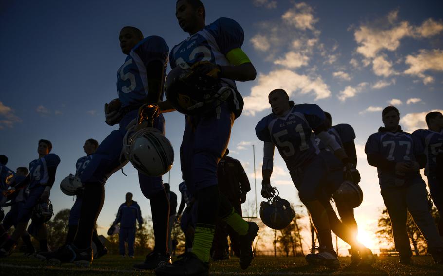 Players from the DODDS-Europe high school football all-star South squad move toward the sidelines before the start of the game Saturday night in Wiesbaden, Germany.