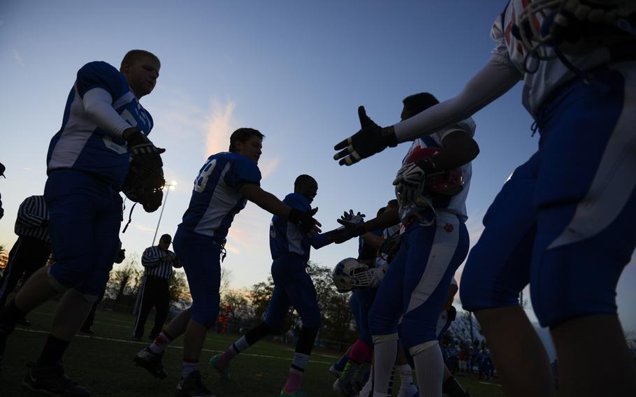 Team captains from the North squad and the South squad shake hands after the coin toss Saturday night before the start of the DODDS-Europe high school football all-star game in Wiesbaden, Germany.