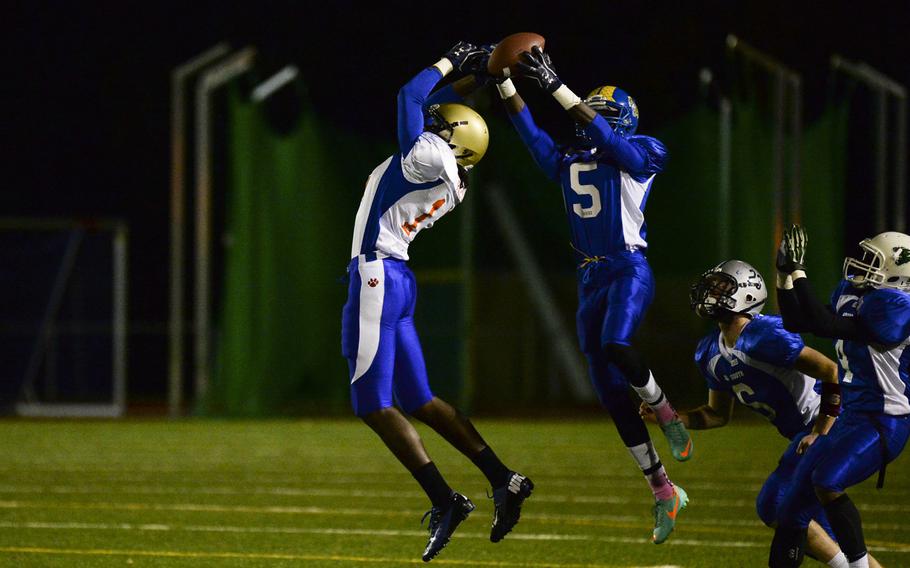 South squad's Brian Debel intercepts a pass intended for North squad's CJ Pridgen ON Saturday night in the DODDS-Europe high school football all-star game in Wiesbaden, Germany.