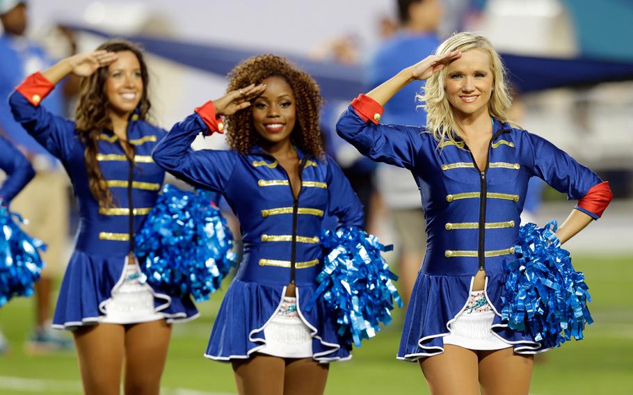 MIami Dolphins cheerleaders perform during the second half of an NFL football game against the San Diego Chargers, Sunday, Nov. 17, 2013, in Miami Gardens, Fla.