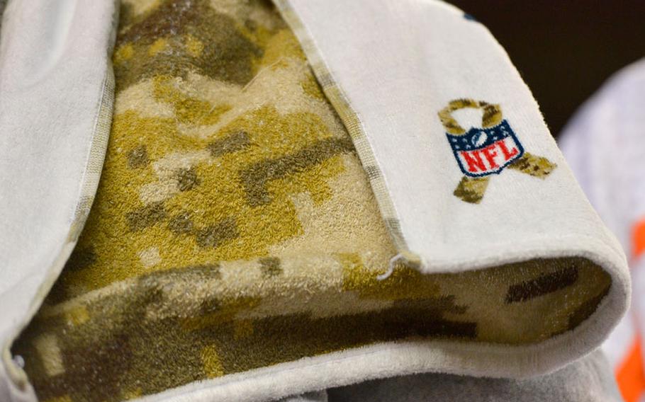 An NFL logo adorns a camouflage patterned towel on the sidelines before an NFL football game between the Denver Broncos and the Kansas City Chiefs, Sunday, Nov. 17, 2013, in Denver. The Broncos honored members of the military with various "Salute to Service" ceremonies before and during the game.