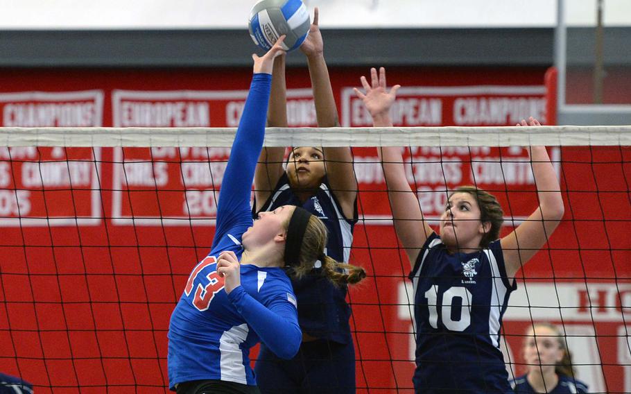 Ramstein's Sarah Schiller, left, battles Lakenheath's Jourdan Hodge and Bailee Hughes in an opening day Division I match at the DODDS-Europe volleyball championships. The two teams later met in the finals. Schiller and Hodge were selected to the 2013 DODDS All-Europe volleyball team
