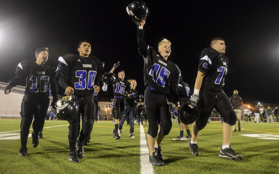 Hohenfels players celebrate after defeating SHAPE to win the DODDS-Europe Division II football championship at Kaiserslautern High School Stadium, Germany, Saturday, Nov. 2, 2013.