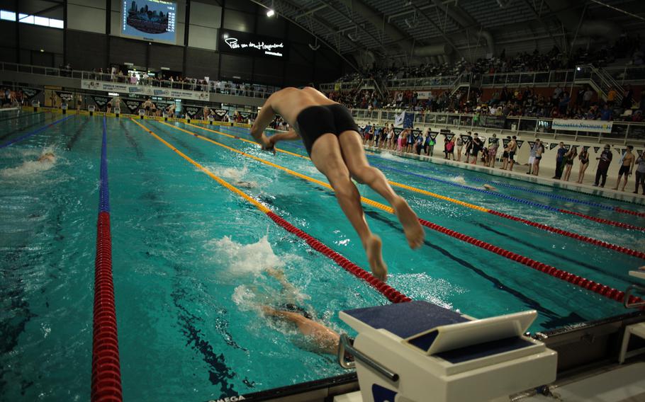 A coach dives into the water during the coaches relay Sunday, Feb. 16, 2014, at the European Forces Swim League championships in Eindhoven, Netherlands. 