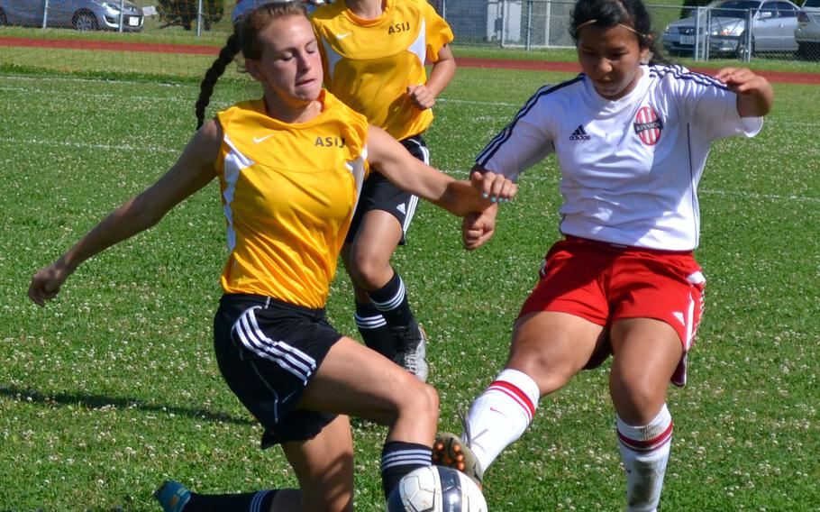 American School In Japan's Katey Helwick and Nile C. Kinnick's Alyssa Arredondo battle for the ball in Wednesday's Far East Girls Division I Soccer Tournament semifinal. ASIJ won 2-1 in penalty kicks.
