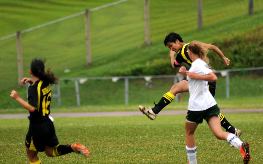 American School in Japan's Joey Yamada leaps into a kick at the Far East Division1 girls soccer championship at Camp Foster, Okinawa, May 22, 2014.