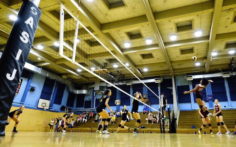 Zama's Destiny Howze attempts a spike kill during her team's visit to American School in Japan Sept. 23 in Chofu, Japan. ASIJ won in straight sets.