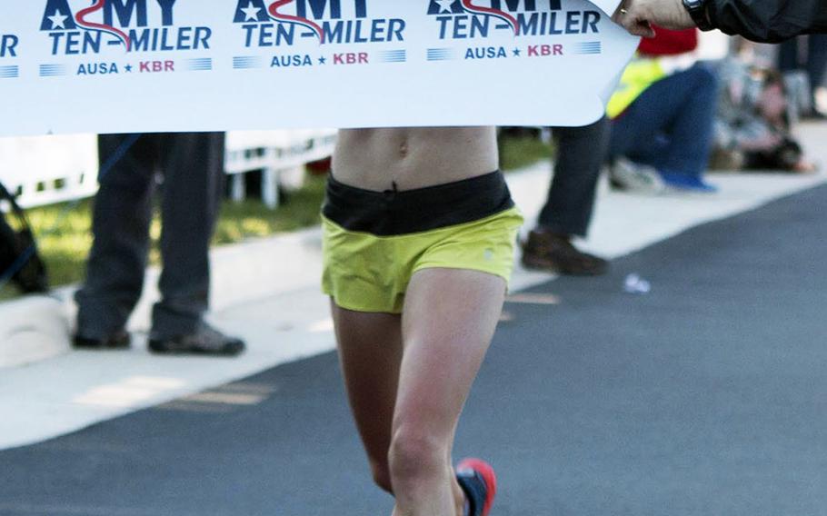 Kerri Gallagher is the first woman to cross the finish line at the 2014 Army Ten-Miler, October 12, 2014.  