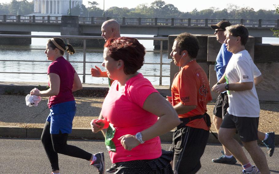 Runners pass the Jefferson Memorial during the 30th Army Ten-Miler in Arlington, Va. and Washington, D.C., Oct. 12, 2014.