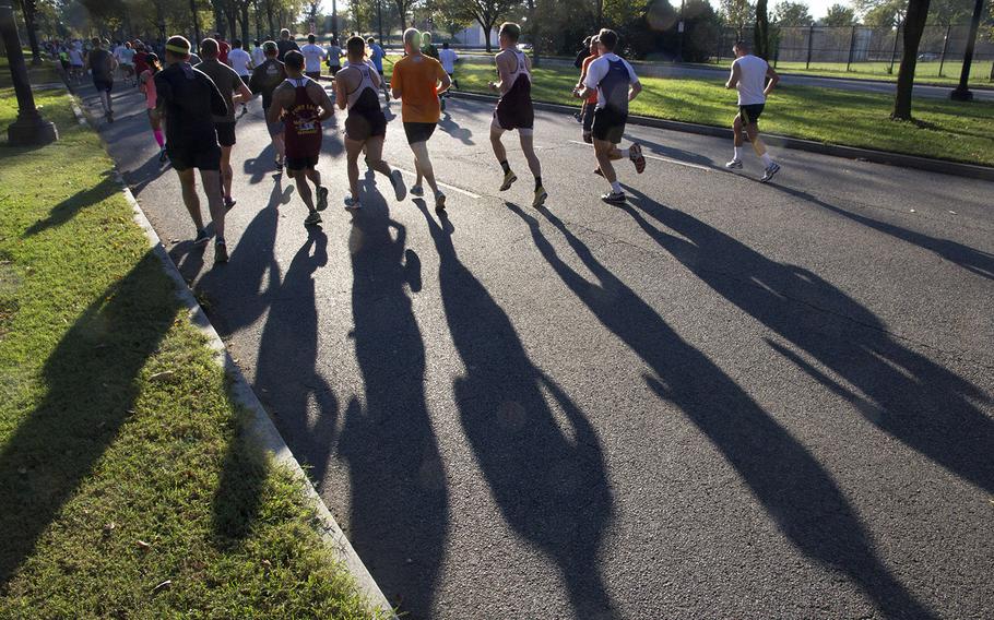 The early-morning sun casts long shadows during the 30th Army Ten-Miler in Arlington, Va. and Washington, D.C., Oct. 12, 2014.