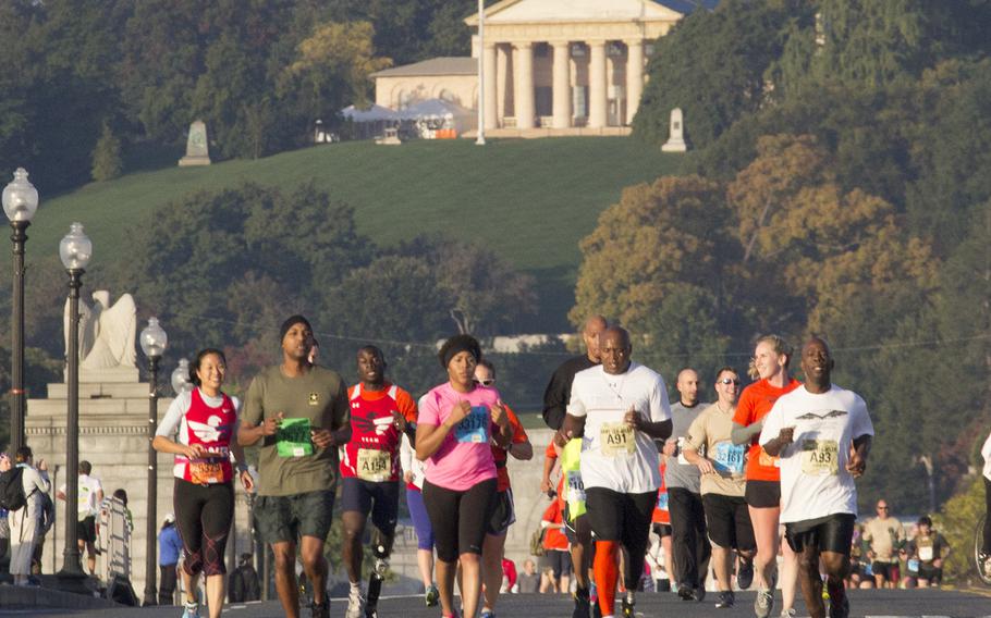 Wounded Warrior competitors cross the bridge into Washington, D.C. during the 30th Army Ten-Miler, Oct. 12, 2014.