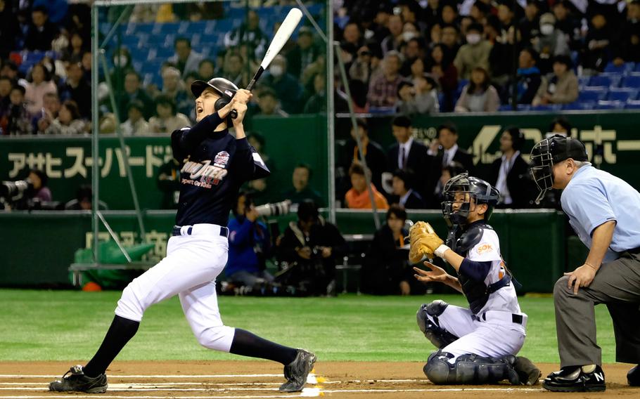 William Eagmin of M.C. Perry High School in Iwakuni, Japan, reacts after missing contact on a 2-1 count in the 1st inning of the '2 with 55 Tomodachi Game' at the Tokyo Dome Saturday, March 21, 2015. The 3-inning charity game raised funds for victims of the 2011 earthquake and tsunami in northern Japan.