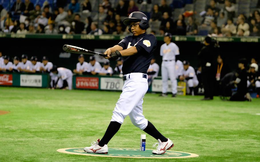 DeShon Morris of Nile C. Kinnick High School in Yokosuka warms up while on deck during the '2 with 55 Tomodachi Game' at the Tokyo Dome Saturday, March 21, 2015. The 3-inning charity game raised funds for victims of the 2011 earthquake and tsunami in northern Japan.