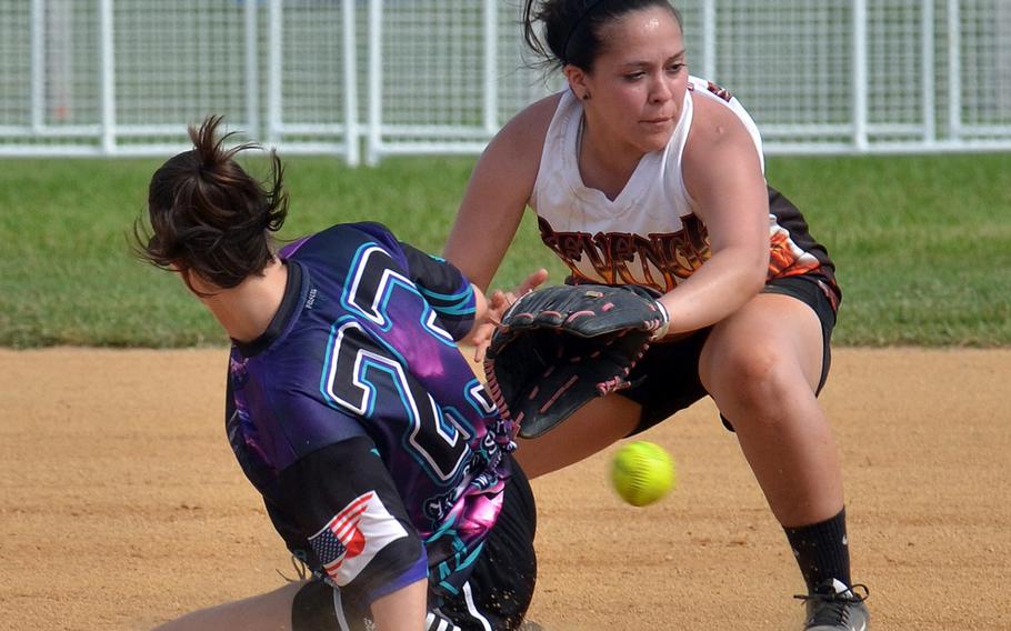 Okinawa Dragons base runner Megan Eliz slides in safely at second just ahead of a throw to Revenge shortstop Danielle Powdrill during Saturday's women's championship game of the Firecracker Shootout Softball Tournament. Dragons won their third straight title 4-3.