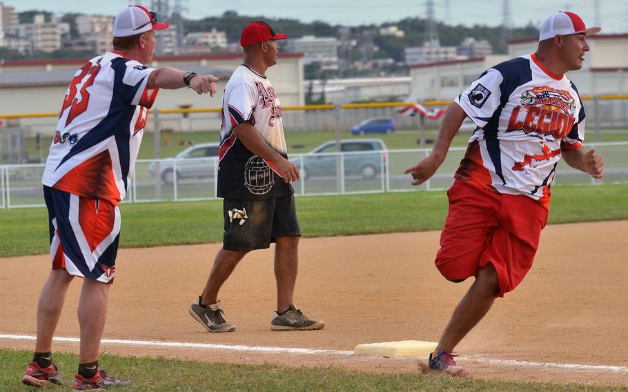 American Legion's Robert Gullett rounds third base for home past Legion coach John O'Brien and Pour House third baseman Anthony Velarde during Saturday's Game 1 of a two-game men's final in the Firecracker Shootout Softball Tournament. Legion scored five seventh-inning runs and won 9-4, forcing a second "if necessary" game, which Pour House won 13-12 for its second Firecracker title in three years.