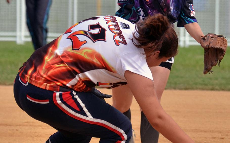 Revenge baserunner Mercedez Abadia ducks out of the way of a double-play relay throw by Okinawa Dragons second baseman Megan Eliz during Saturday's women's championship game of the Firecracker Shootout Softball Tournament. Dragons won their third straight title 4-3.