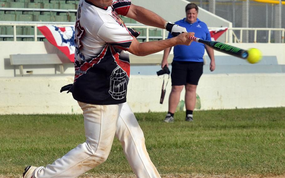 Pour House's Ben Sanchez makes contact against American Legion during Saturday's Game 1 of a two-game men's final in the Firecracker Shootout Softball Tournament. Legion won 9-4, forcing a second "if necessary" game, which Pour House won 13-12 for its second Firecracker title in three years.