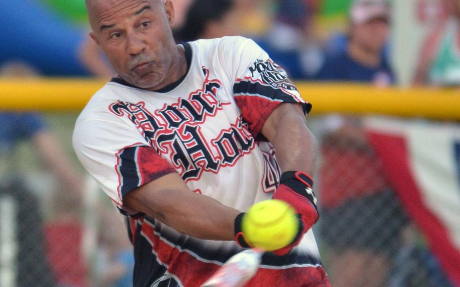 Lawrence Occomy of Pour House connects against American Legion during Saturday's Game 2 of a two-game men's final in the Firecracker Shootout Softball Tournament. Pour House won 13-12 for its second Firecracker title in three years, after Legion had forced the second game by winning the first final contest 9-4.