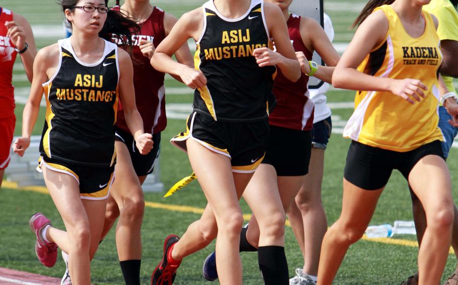 Senior Tatiana Riordan, center, of American School In Japan feels her Mustangs have a strong cross country team this year and have a good shot at repeating Far East meet Division I team honors.