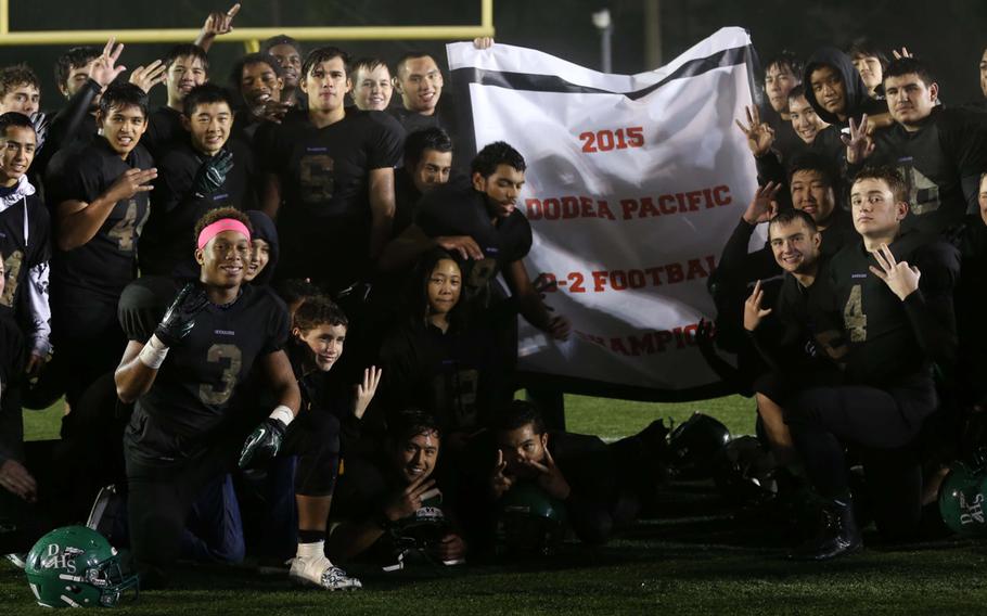 Daegu players and coaches gather round the victory banner.