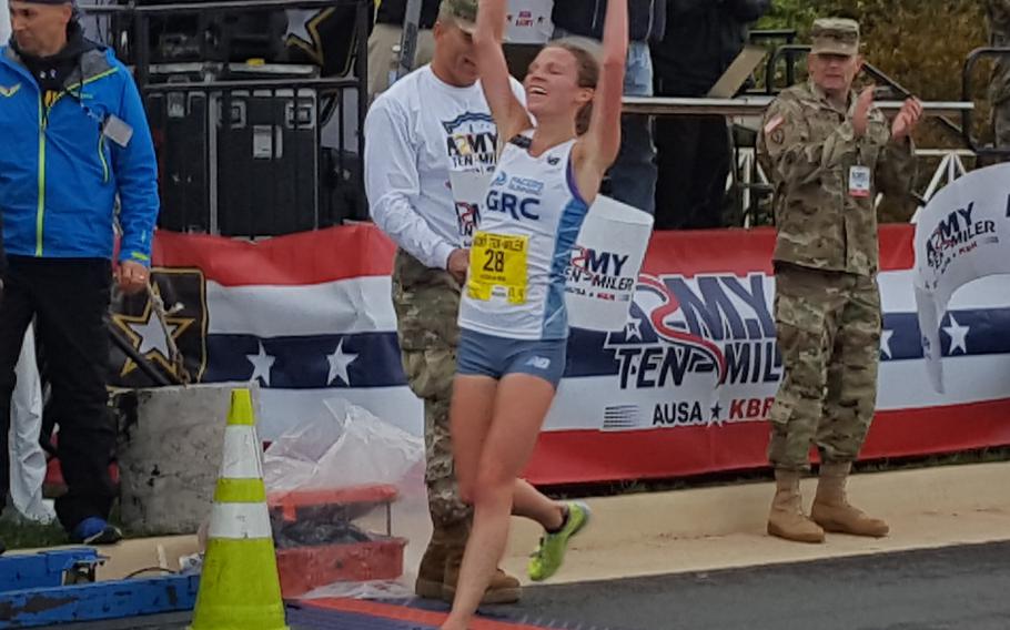 Stephanie Reich crosses the finish line as the first female finisher in the Army Ten-Miler, Oct. 9, 2016.