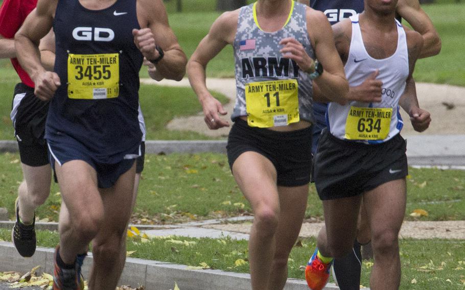 Kelly Calway (11) of West Point, N.Y. leads a group of runners toward the five-mile mark in Washington, D.C. during the Army Ten-Miler, Oct. 9, 2016. Calway was the third female finisher, in a time of 58:56.