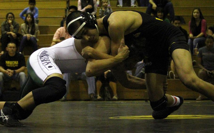 Kadena sophomore Demetrius De La Rosa, right, wrestling against Kubasaki's Luis Veliz, won at 101 pounds in the Far East tournament a year ago.
