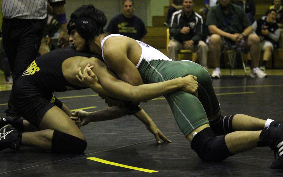 Kubasaki senior Kyan McCarty, top, wrestling against Kadena's Austin Martino, finished third in last year's Far East tournament at 108 pounds.